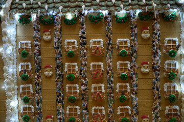 christmas gingerbread house decoration with cookies, candy and white icing like snow