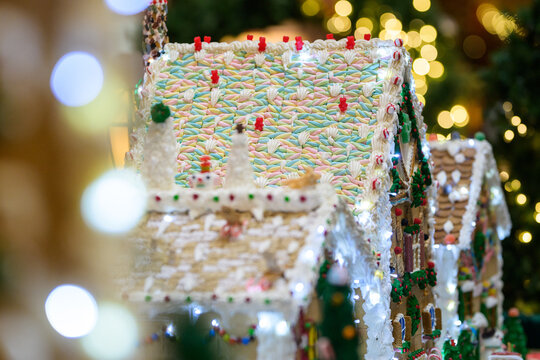 christmas gingerbread house roof with decorations with snowman candy and white icing like snow