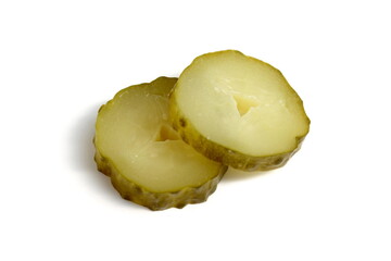 Sliced ​​pickled cucumbers lie on a white background.	
