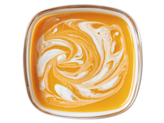 Creamy swirl of vibrant orange soup in a modern square bowl, a comforting and delicious meal.