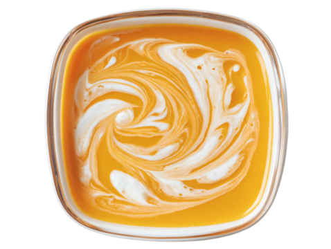 Creamy swirl of vibrant orange soup in a modern square bowl, a comforting and delicious meal.