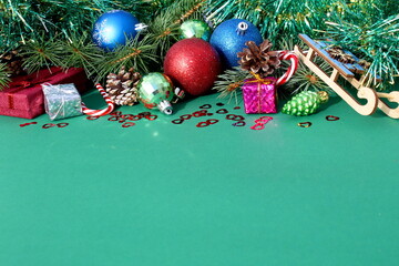 There are New Year's Christmas decorations on a green background.	