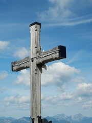 Back of the summit cross with edelweiss on the Kehlstein. Symbol of Alps, tradition, and nature. Copyspace.