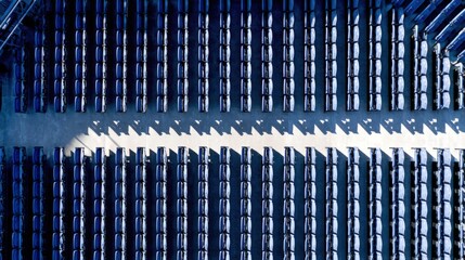 Empty bleachers arranged in neat rows under bright sunlight
