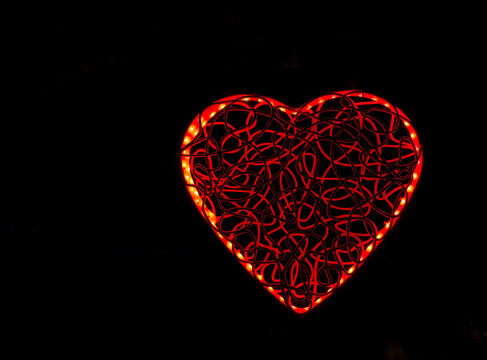 Glowing Red Heart Shape on Black Background – Romantic Love Symbol, Valentine’s Day Concept