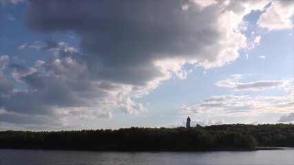 MURMANSK, RUSSIA - AUGUST 17, 2023: Monument to ALYOSHA against the backdrop of picturesque clouds flying rapidly in the blue sky on a summer evening. Timelapse.
