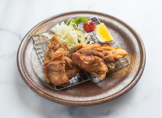 Japanese fried karaage chicken, perfectly fried with lemon. Ideal for restaurant menus, food blogs, or culinary projects seeking delicious cuisine.