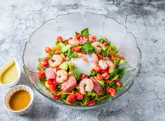 Seafood salad with poached egg, avocado and tomatoes. Perfect for a healthy lunch or light dinner. Showcase vibrant colors and textures.