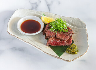 Awajioka Skirt Steak seared wagyu beef paired with zesty lemon and vibrant scallions. Perfect for upscale dining, menus, or food blogs.