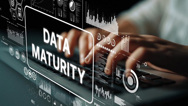 Conceptual illustration of data maturity with digital graphics and hands typing on a keyboard in a modern workspace. Asymptotic smart data analytic.