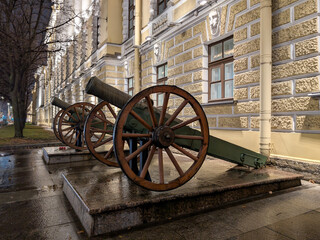 An old cannon near a historic building