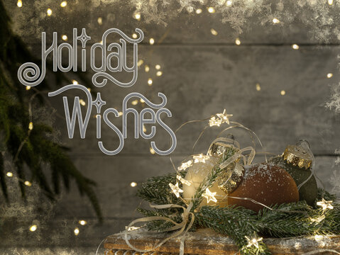 Christmas card Holiday Wishes text. Velvet natural green and brown ball ornaments with snow on wood table with star twinkle lights against Norfolk pine tree and festive plank wood blurry
