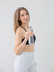 Fit Woman in Athletic Wear Holding Water Bottle After Workout
