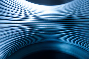 Abstract blue metal curves tunnel background. Futuristic spaceship interior wall texture. Modern sleek steel lines with light reflection. Photo