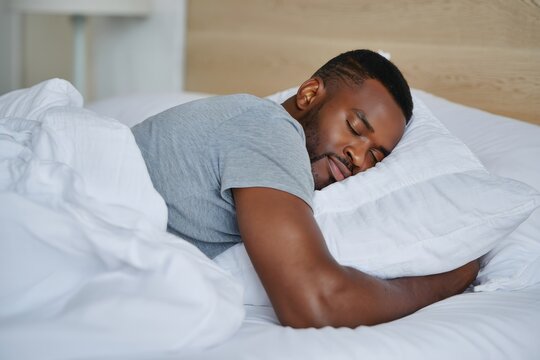 Man sleeping well in bed restful sleep black man sleep concept image
