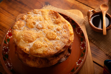 Buñuelos de rodilla. Traditional food at Christmas and winter holidays in Mexico, these are fried dough flour sprinkled with sugar or covered in a syrup made with piloncillo, cinnamon, and guava.