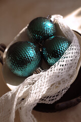 Christmas teal ornaments on plate with lace creating elegant holiday decoration concept of winter home styling and festive interior design