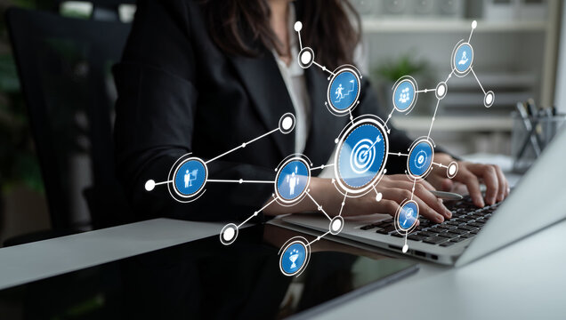 A business professional engages with a laptop, surrounded by digital icons that represent various concepts in productivity and health. The workspace showcases modern technology. Tessel