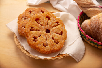 Buñuelos de viento. Traditional food at Christmas and winter holidays in Mexico, these are fried dough flour sprinkled with sugar or covered in a syrup made with piloncillo, cinnamon, and guava.