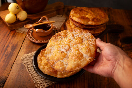 Bu&ntilde;uelos de rodilla. Traditional food at Christmas and winter holidays in Mexico, these are fried dough flour sprinkled with sugar or covered in a syrup made with piloncillo, cinnamon, and guava. POV