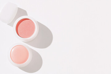Lip balm on a white background and pink lip balm