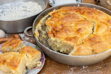 Rural Moldovan Grandma Preparing Traditional Homemade Cheese Pastry. Authentic Village Cooking. Healthy Old Customs in Moldova.
