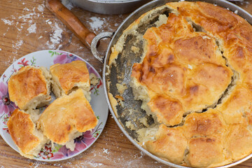 Rural Moldovan Grandma Preparing Traditional Homemade Cheese Pastry. Authentic Village Cooking....