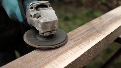 Old wood ginding. Closeup video of a worker or a craftsman working with wood. Sanding and polishing the wood. Home renovation and improvement work.