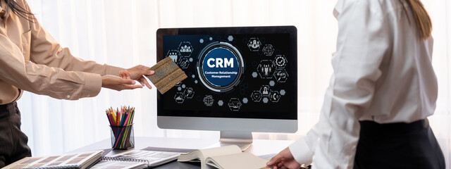 Group of interior architect designer team at table choosing various mood board samples with architecture software on laptop screen. Modern renovation and interior material selection concept. Insight