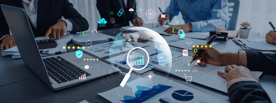 Professional team in a business meeting analyzing data with digital tools and graphs. Focus on teamwork and strategies in a modern office setting. Trope