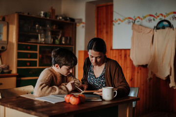 Single mother doing homework with her daughter during hard times.