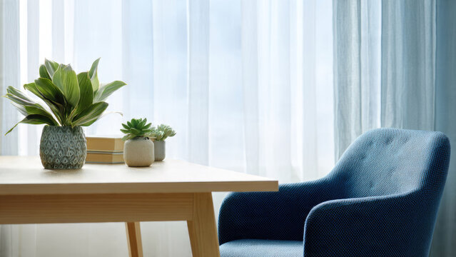 A bright, serene interior scene featuring a wooden table with potted plants and a blue upholstered chair next to a window with sheer curtains.