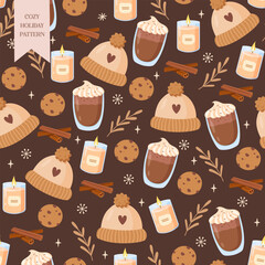 Seamless cozy winter holiday pattern on dark brown background with knitted hats, cocoa mug, burning candle, cinnamon sticks, Christmas cookies, decorative plant branches and snowflakes 