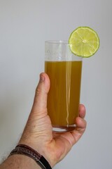 Fresh Sugarcane Juice with Lime on Sugarcane Stalks