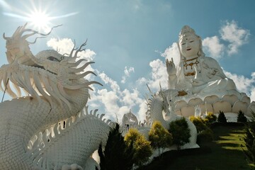 Wat Huay Pla Kang a modern Buddhist temple in Chiang Rai, Thailand. massive white statue of Guan Yin, the Goddess of Mercy guarded by dragon sculptures