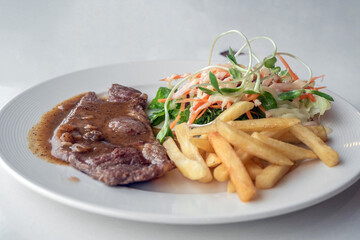 Close up of Grilled beef steak, boiled french fries and vegetable salad;Selective focus
