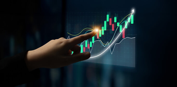 A hand points at a financial graph with green and red candlesticks, indicating growth and trends. The dark background highlights the data visualization in analytics. Impute