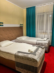 Hotel room featuring two twin beds setup for guests