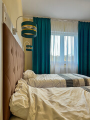 Hotel room with twin unmade beds