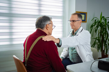 Fototapeta premium Doctor offers care to an elderly patient in a bright office