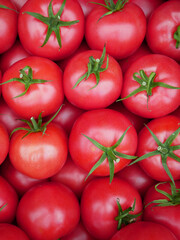 Raspberry tomatoes photographed at the market on a sunny spring day. Organic food from Poland. Tasty and sweet vegetables rich in vitamins. Close up. 