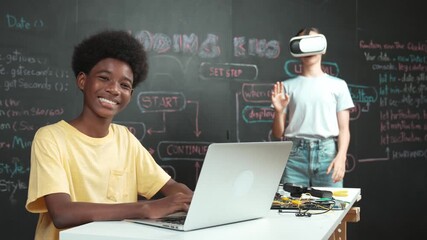 Smart african student programming and coding innovative system while caucasian girl enter in metaverse or virtual world by using VR or head set at blackboard in STEM technology classroom. Edification - Powered by Adobe