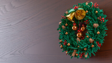 Christmas Wreath with Golden Bells on Wooden Background 3d render
