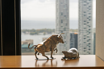 Bull and bear in front of downtown scene