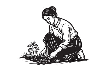 Woman tending to a small plant in a garden