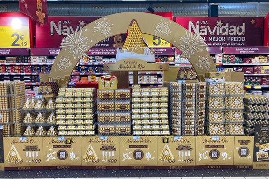 A festive Ferrero Rocher Christmas window display at Carrefour in Torremolinos, Spain, showcases golden decorations and elegant seasonal branding.