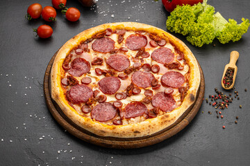 Fresh pepperoni pizza on wooden board with salami, sausage and spices, top view