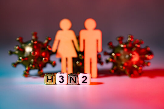 Abstract representation of a couple holding hands, with virus models and H3N2 text blocks in the foreground, symbolizing health awareness and pandemic impact on relationships
