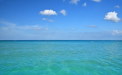 Blue ocean water meeting clear sky horizon