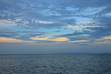 Tranquil sea and sky at blue hour sunrise